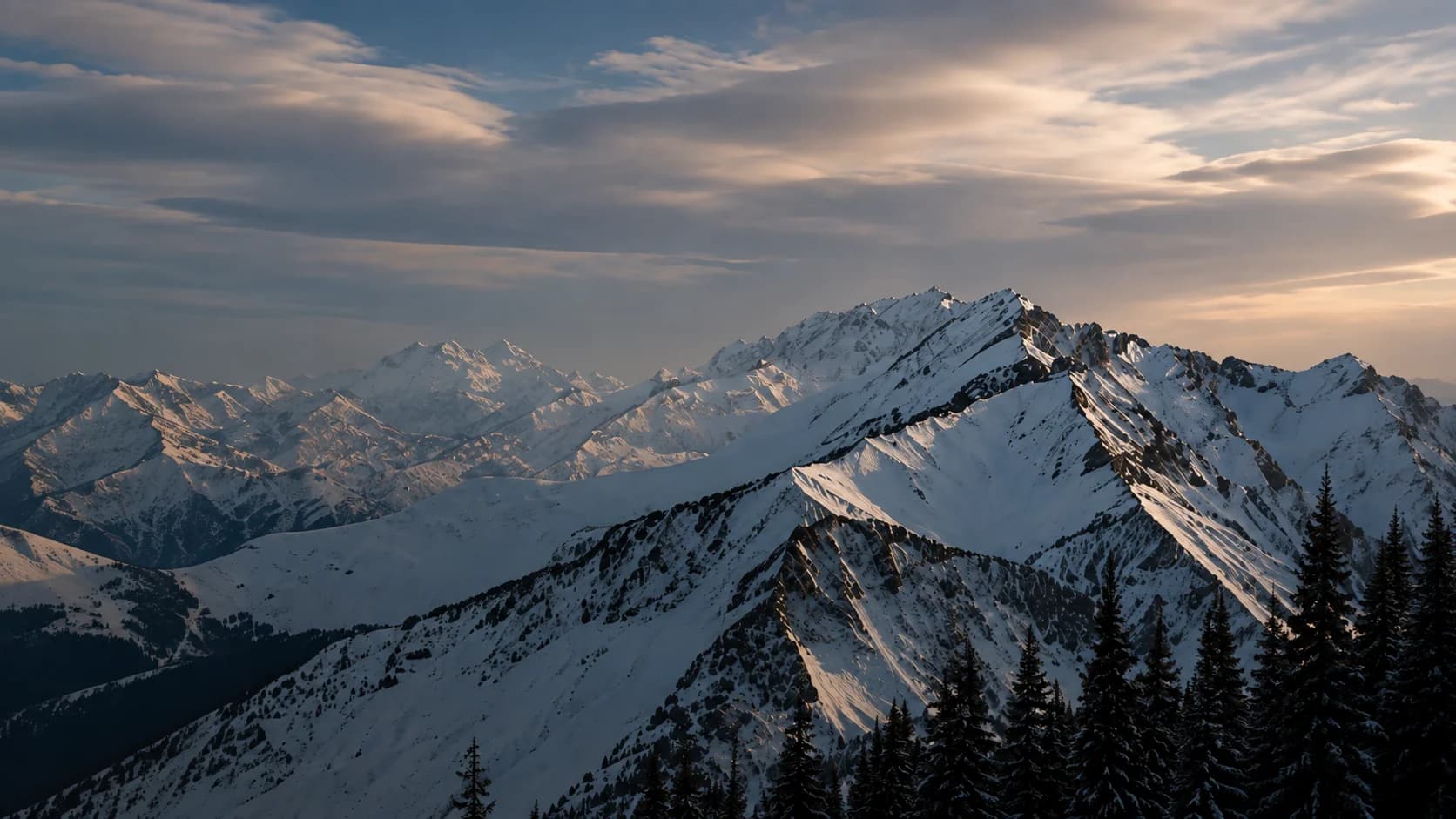 Snow-covered alpine mountain peaks at dusk