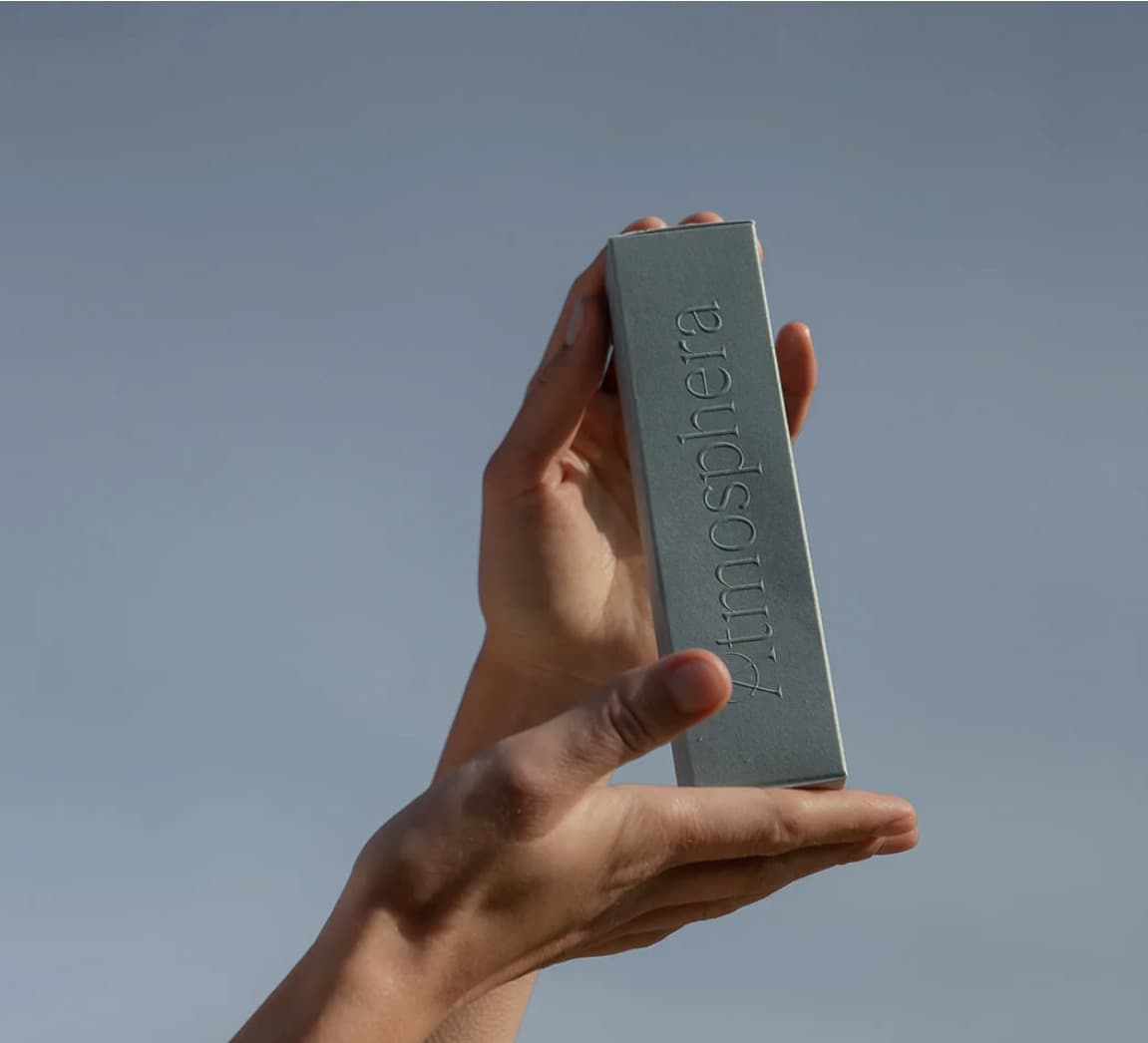 Hand holding Atmosphera product box